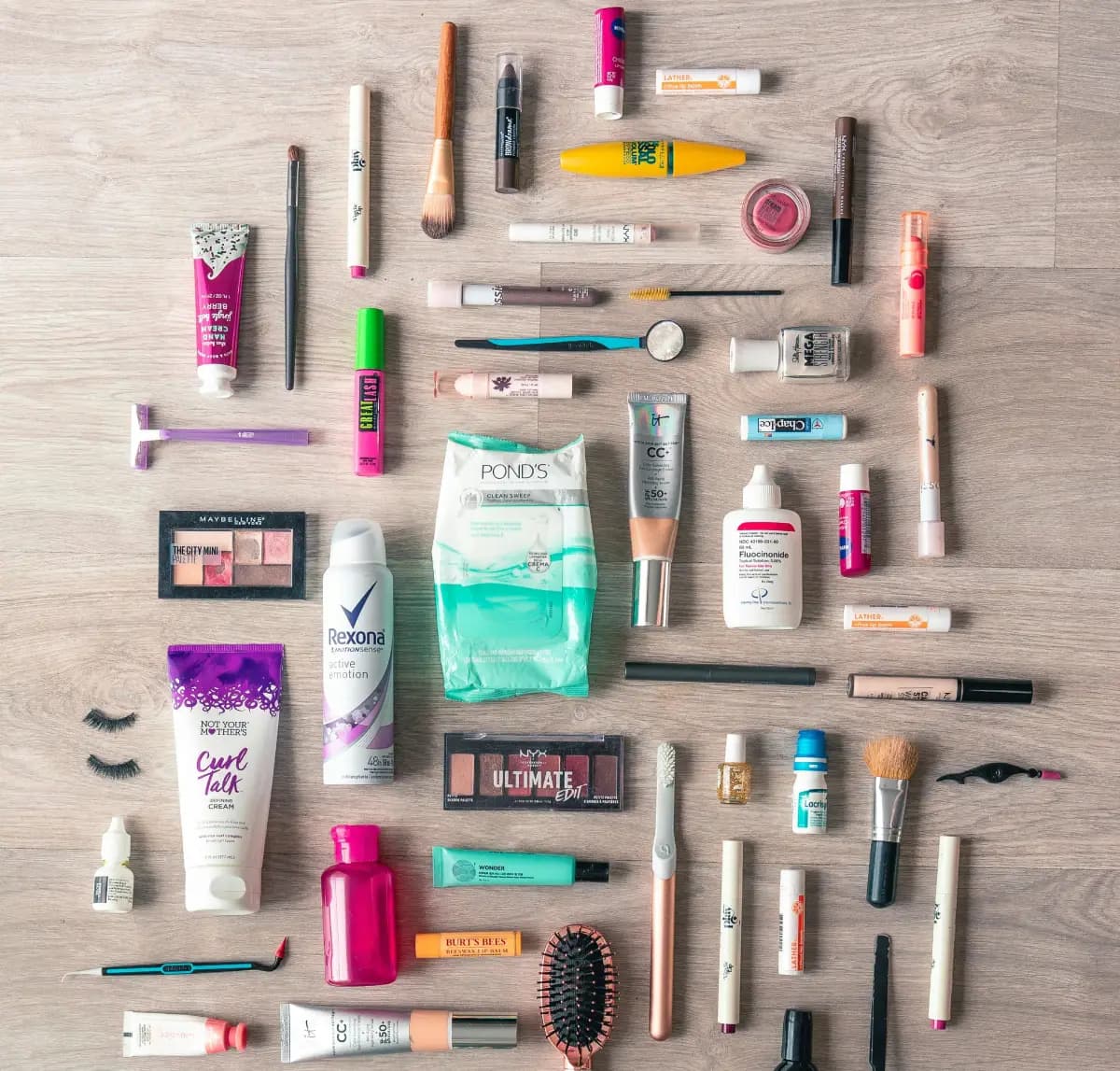 Various skincare and beauty products including bottles, jars, and tubes with ingredient labels visible, arranged on a bathroom counter